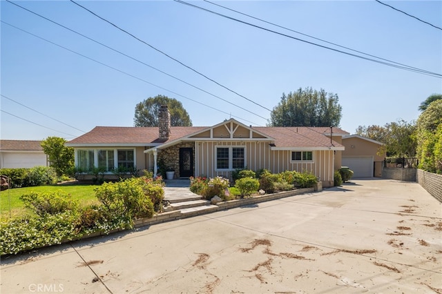 ranch-style home featuring a garage and a front lawn