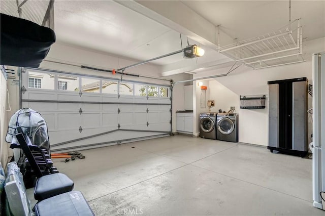 garage with a garage door opener and washing machine and dryer