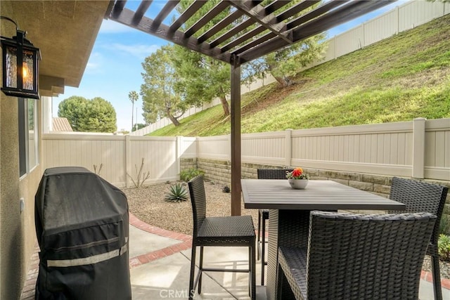 view of patio / terrace with outdoor dining space, a fenced backyard, a grill, and a pergola