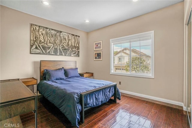 bedroom with recessed lighting, dark wood finished floors, and baseboards