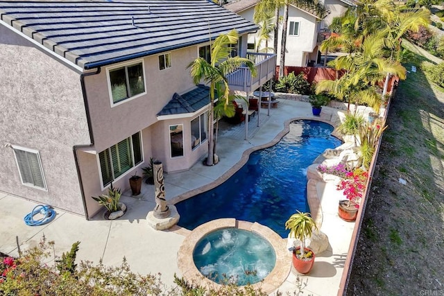 view of pool featuring a patio area, a fenced in pool, and an in ground hot tub