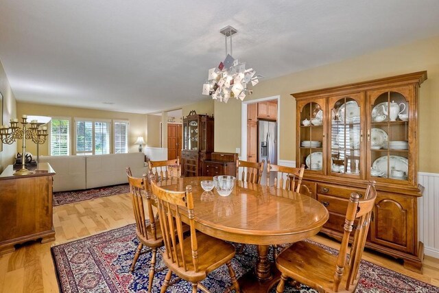 dining area featuring a notable chandelier and light wood-style floors