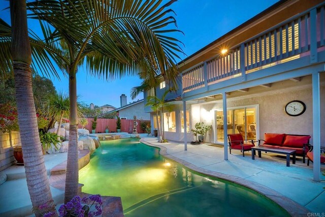 view of swimming pool featuring a patio area, an outdoor living space, a pool with connected hot tub, and fence