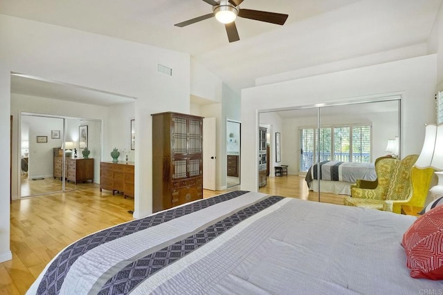 bedroom with wood finished floors, visible vents, a closet, and ceiling fan