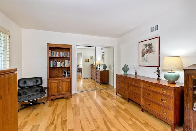 living area featuring visible vents and light wood-style flooring