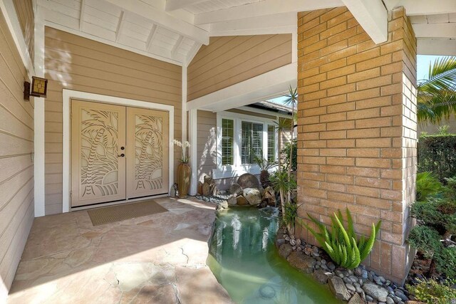 property entrance featuring brick siding