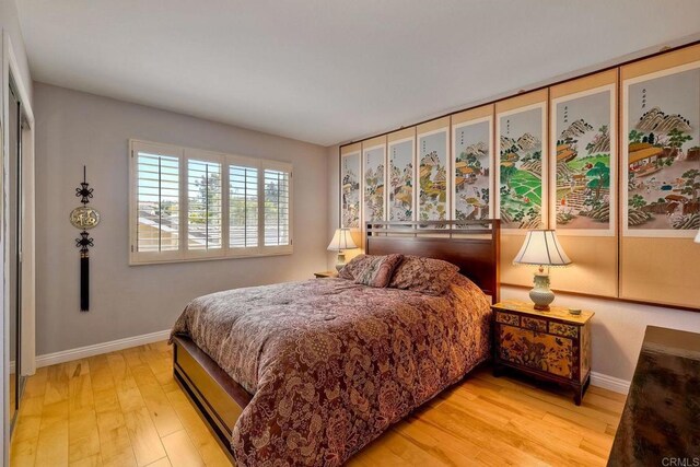 bedroom featuring baseboards and light wood-style floors