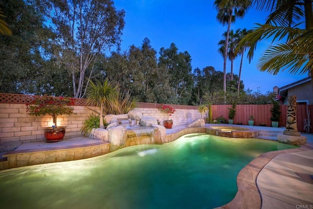 view of swimming pool featuring a patio area, a fenced backyard, and a pool with connected hot tub