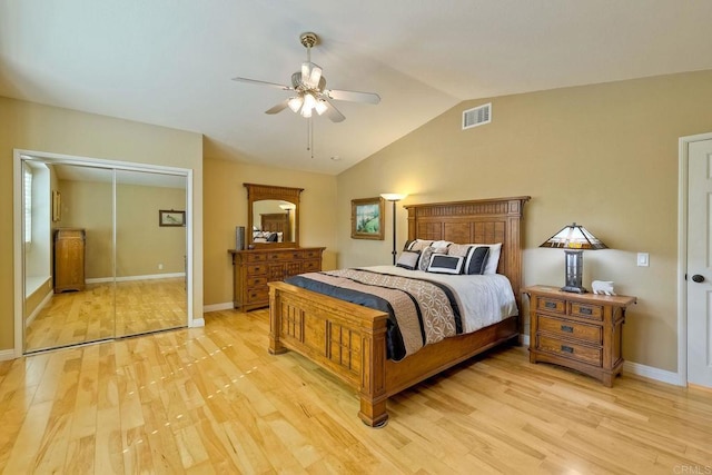 bedroom with light wood-type flooring, visible vents, baseboards, and vaulted ceiling