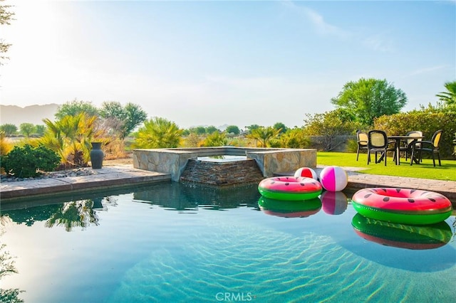 view of pool with a lawn