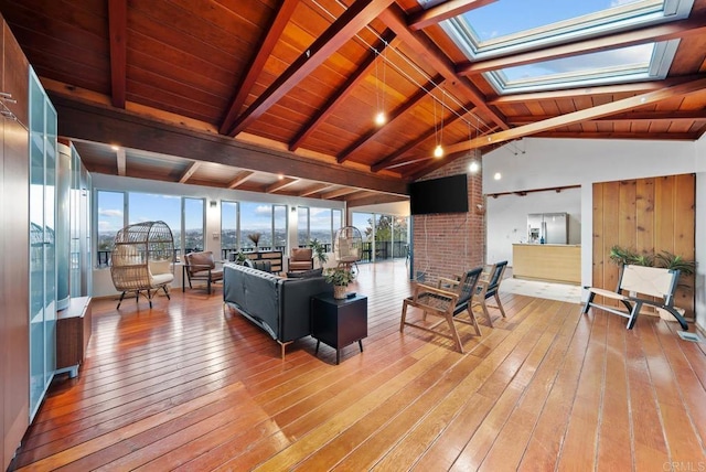 living room featuring wood ceiling, lofted ceiling with skylight, and light wood-style flooring