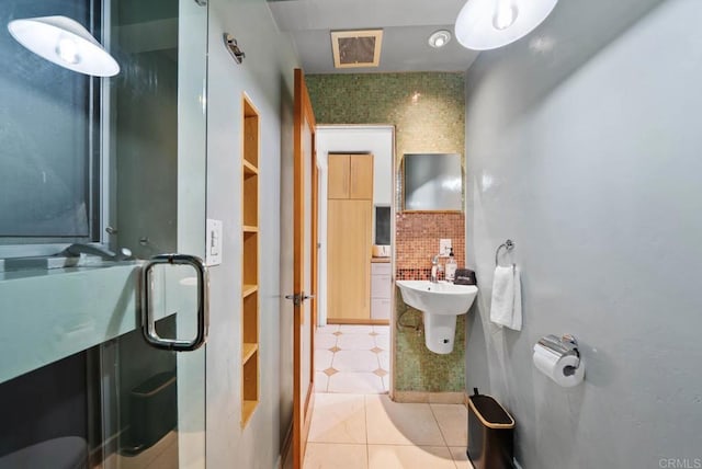 bathroom featuring a sink, tile patterned flooring, and visible vents