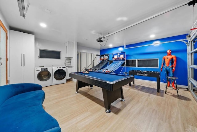 playroom with a garage, light wood finished floors, washing machine and dryer, and baseboards