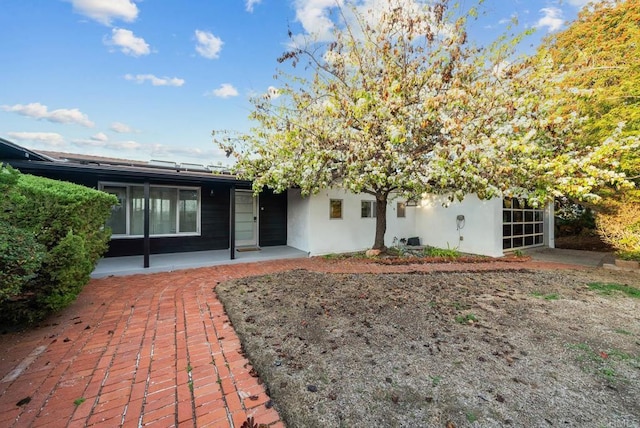 rear view of property with stucco siding