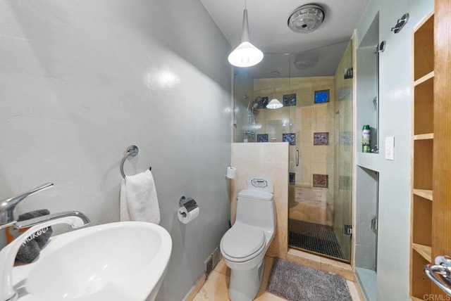 full bathroom featuring tile patterned flooring, a sink, toilet, and a shower stall