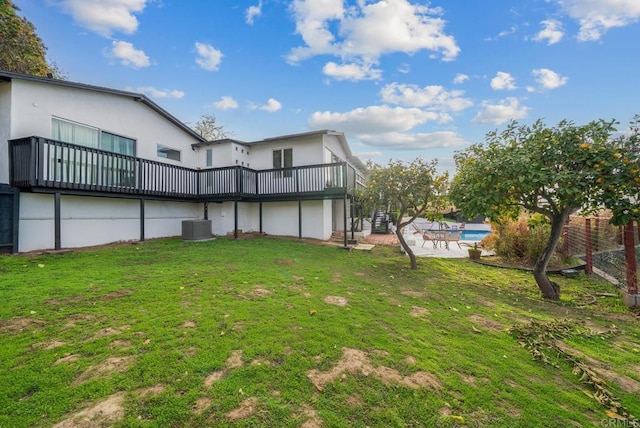 view of yard with a patio, central air condition unit, stairway, a wooden deck, and an outdoor pool