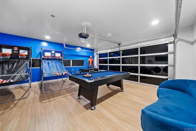 playroom featuring a garage, pool table, and wood finished floors