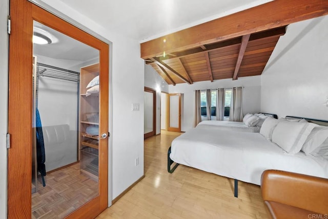 bedroom featuring lofted ceiling with beams, light wood-style floors, baseboards, and wooden ceiling