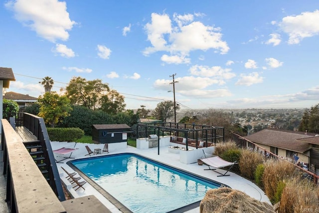 view of pool featuring a fenced in pool, a patio, an outdoor structure, and fence