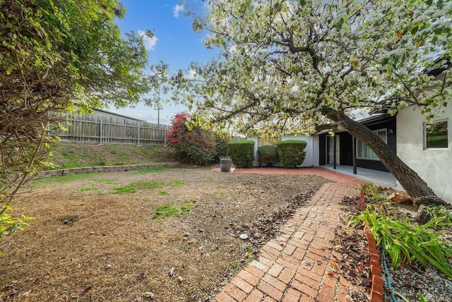 view of yard featuring a patio area and fence