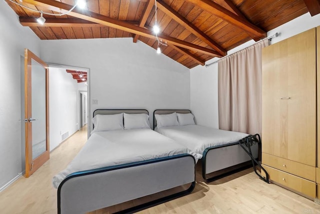 bedroom featuring wood ceiling, visible vents, vaulted ceiling with beams, and wood finished floors