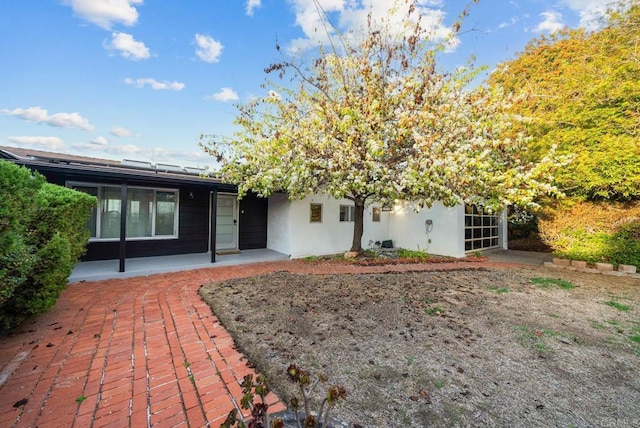 rear view of property with stucco siding