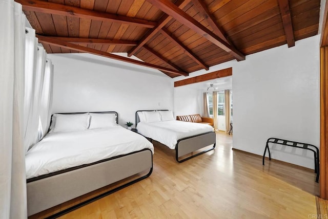 bedroom with vaulted ceiling with beams, light wood-style floors, and wood ceiling