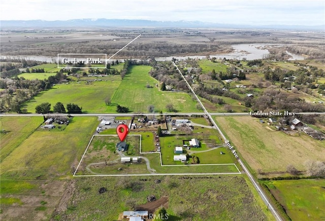 birds eye view of property with a rural view and a water and mountain view