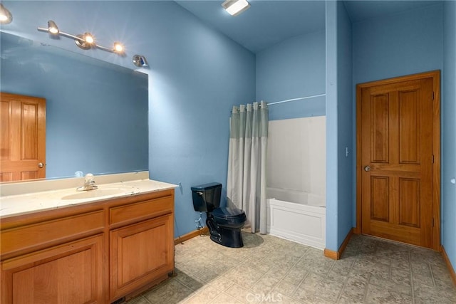bathroom featuring baseboards, shower / tub combo with curtain, vaulted ceiling, and vanity
