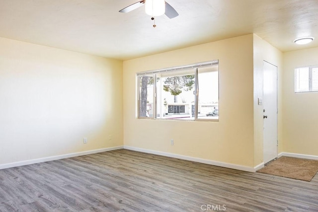 spare room with hardwood / wood-style flooring and ceiling fan