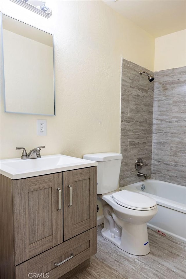 full bathroom featuring hardwood / wood-style flooring, vanity, toilet, and tiled shower / bath combo