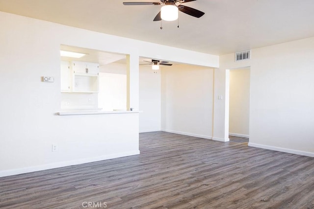 unfurnished room featuring dark wood-type flooring and ceiling fan