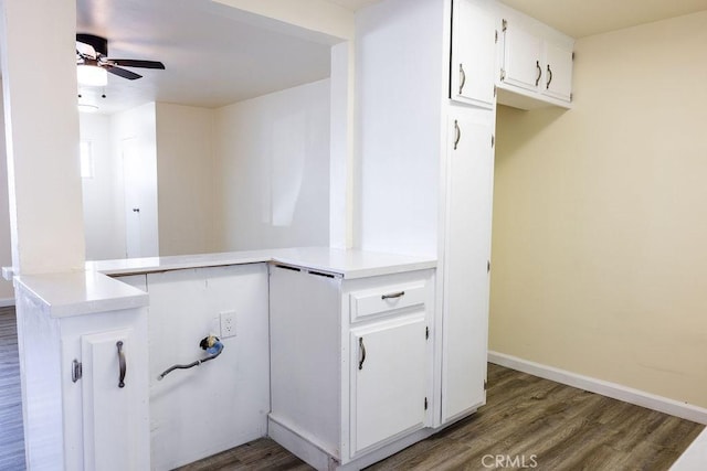 kitchen with white cabinetry, kitchen peninsula, dark hardwood / wood-style floors, and ceiling fan