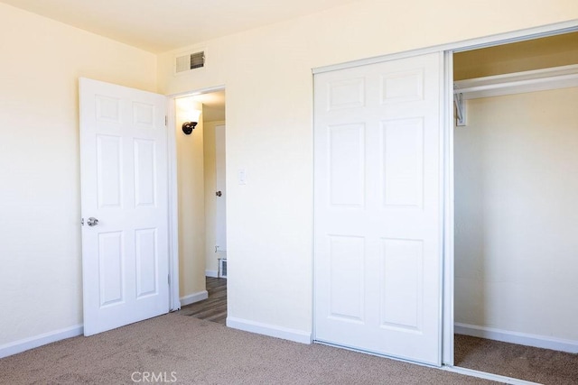 unfurnished bedroom featuring a closet and carpet