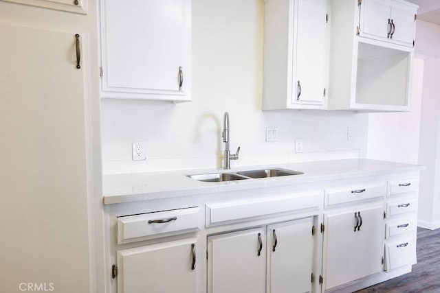 kitchen featuring white cabinetry, sink, and dark hardwood / wood-style flooring