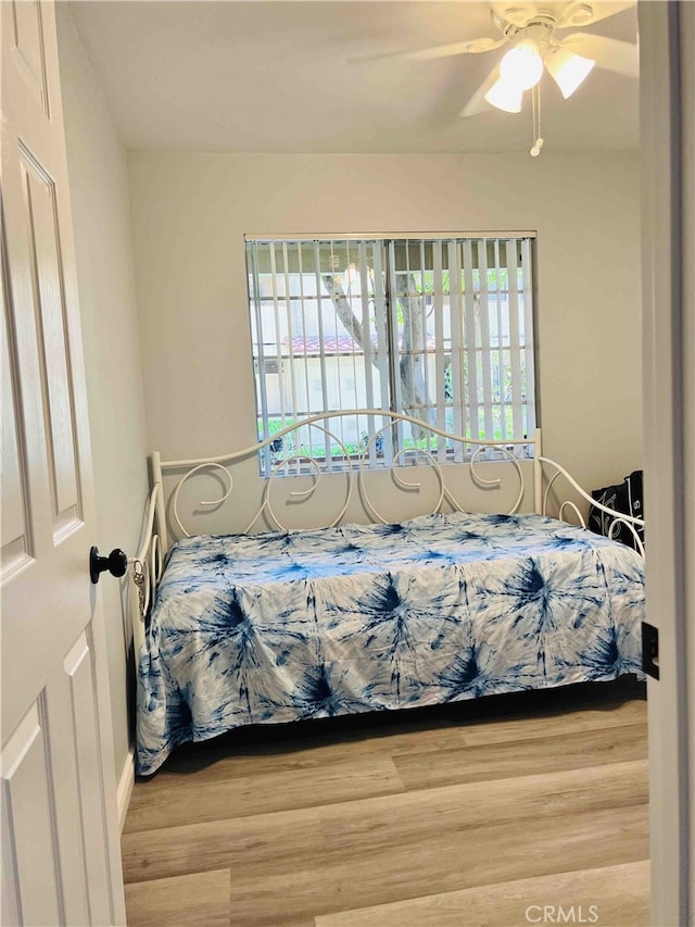 bedroom featuring ceiling fan and light hardwood / wood-style floors