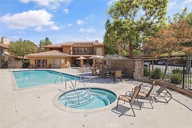 view of swimming pool with a patio and a community hot tub