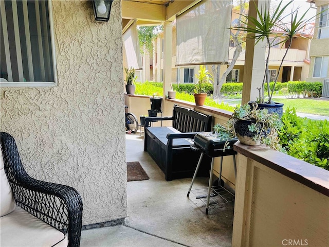 view of patio / terrace with a balcony and central AC unit