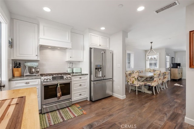 kitchen featuring stainless steel appliances, dark wood-style flooring, visible vents, and white cabinetry