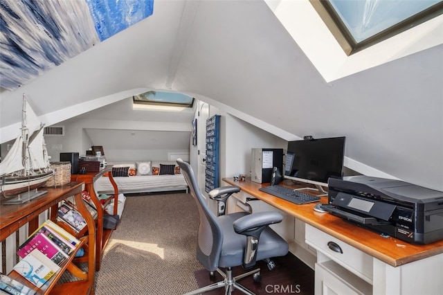 office area with vaulted ceiling with skylight, dark wood-style flooring, and visible vents