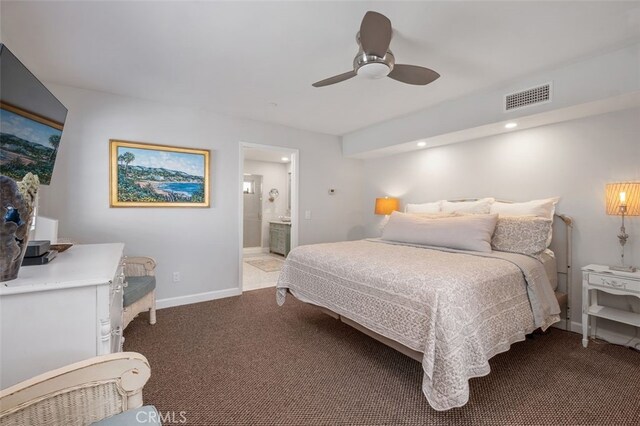 bedroom featuring carpet floors, visible vents, ensuite bathroom, ceiling fan, and baseboards