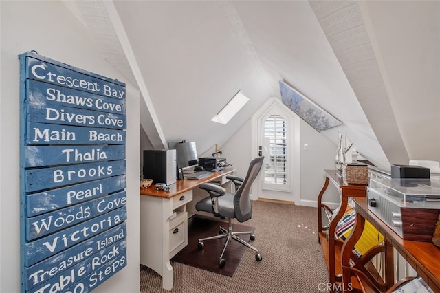 home office with lofted ceiling with skylight, baseboards, and light colored carpet