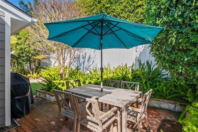 view of patio featuring outdoor dining space and a grill