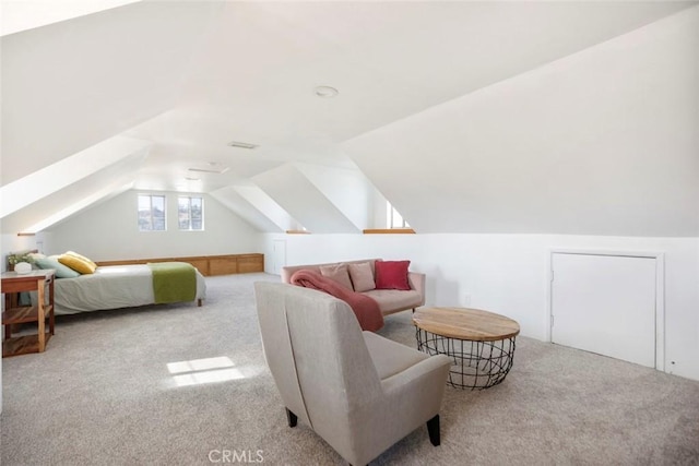 interior space featuring vaulted ceiling and light colored carpet