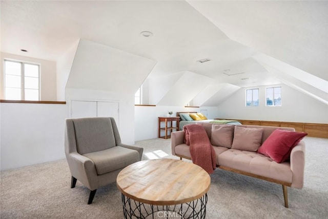 sitting room with vaulted ceiling and light carpet