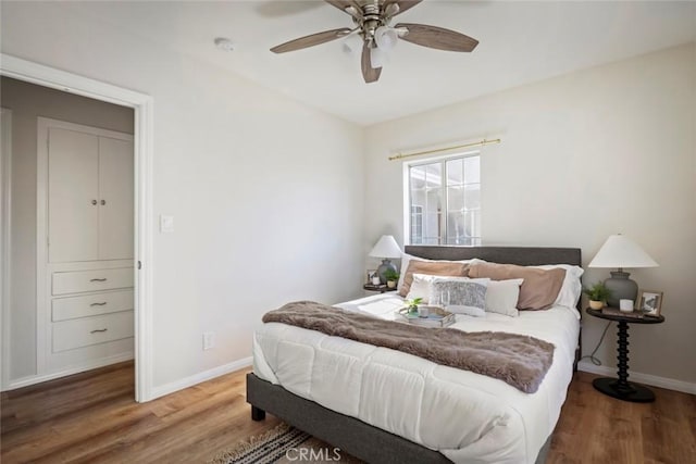 bedroom with wood-type flooring and ceiling fan