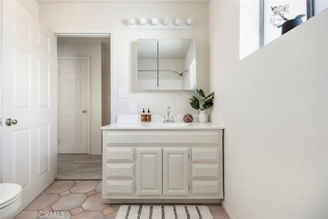 bathroom with vanity, tile patterned floors, and toilet