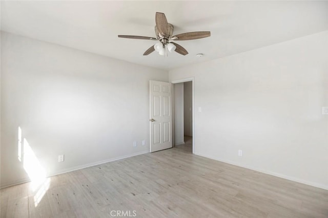 empty room with ceiling fan and light wood-type flooring