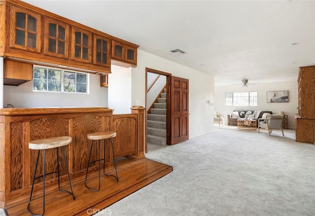 bar with carpet floors and ceiling fan