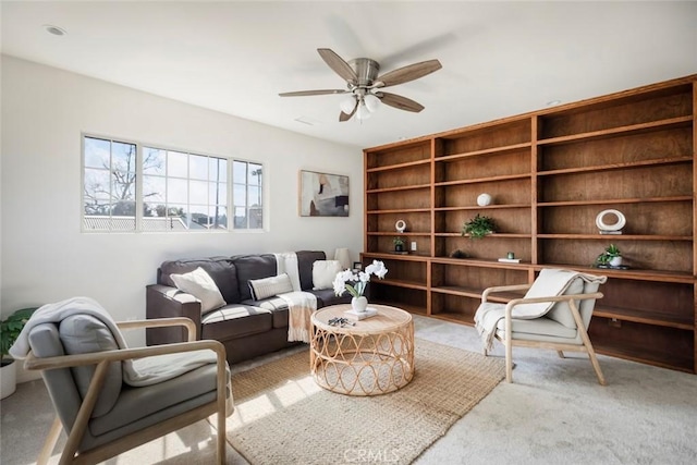 sitting room featuring light carpet and ceiling fan